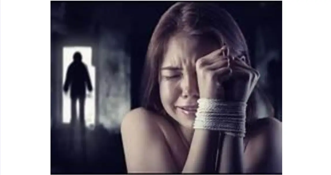 A woman with her hands tied up and crying.