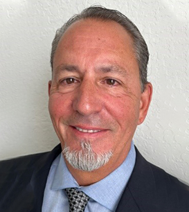 A man with a beard and mustache wearing a suit